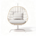 Hanging rattan chair with cushion and metal frame for indoor or outdoor use