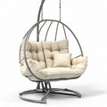 Hanging egg chair with cushion support in beige fabric and metal frame